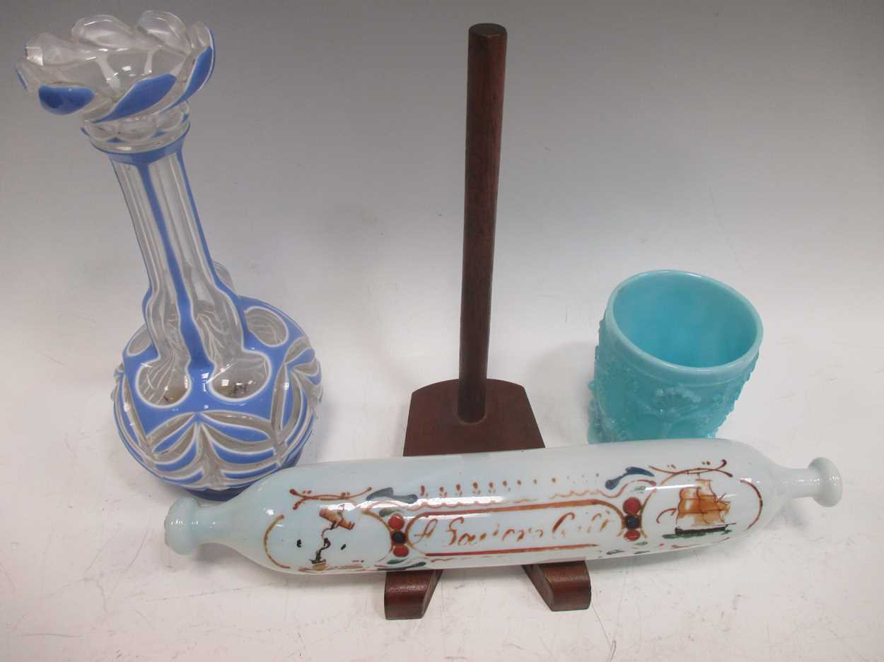 A Nailsea glass rolling pin, 32cm long; a blue pressed glass beaker, 9.5cm high, a Vaseline glass