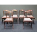 A set of six Regency faux rosewood dining chairs, with scrolled acanthus top-rails, the caned