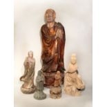 A Chinese lacquered wood figure of a standing lohan, on lotus base, 62.5; and four other lohan /