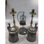 A pair of late 19th century brass candlesticks, a model bird in a suspended cage musical box and a