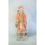 A Chinese painted pottery standing figure of a guard or attendant, perhaps Han Dynasty, 44.5cm