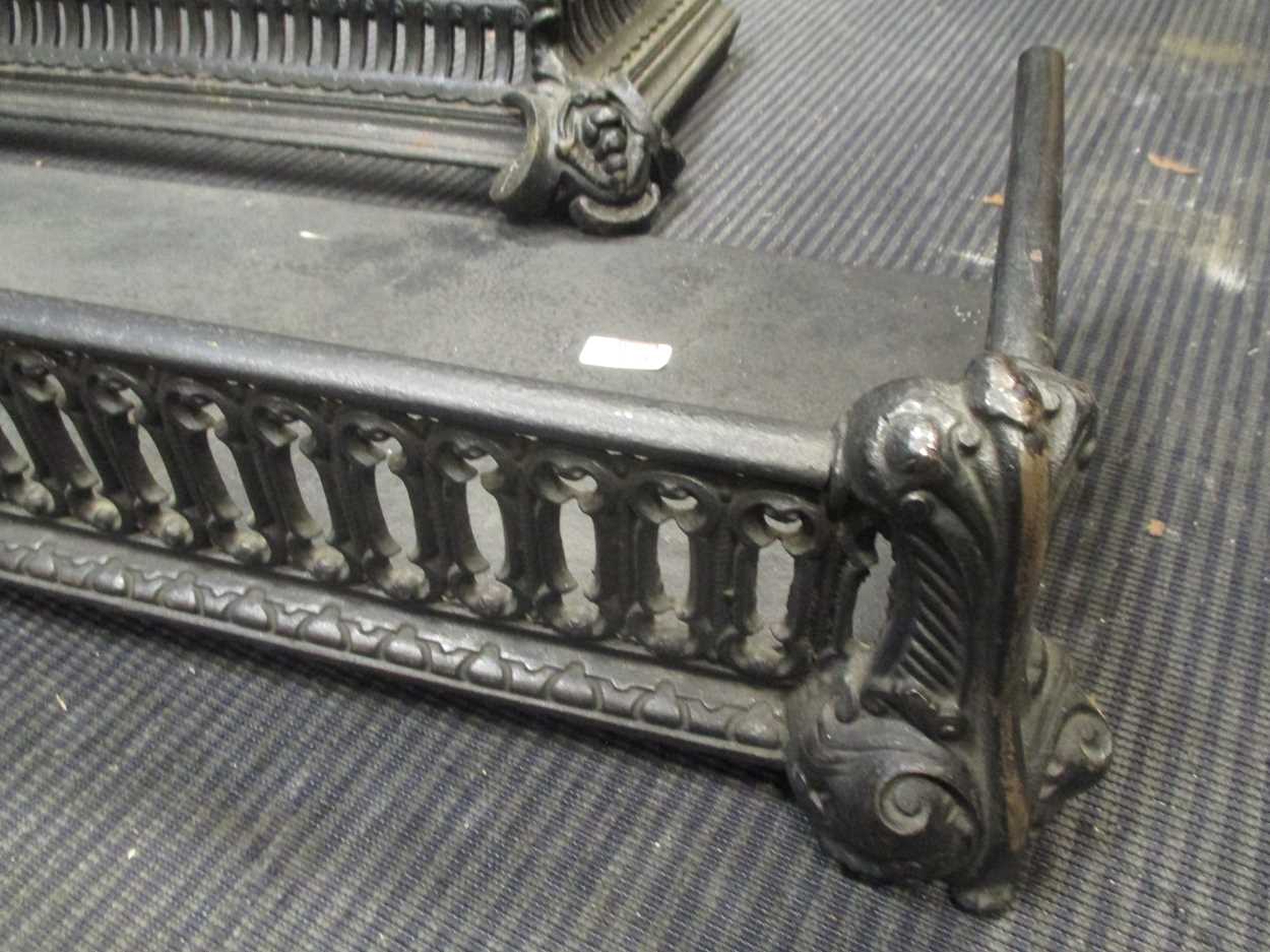 A black pierced steel fender 132cm wide together with a cast iron fender, 93cm wide (2) - Image 3 of 3