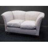 A two seat ivory upholstered fan-back sofa, on mahogany legs with castors 93 x 170 x 97cm