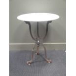 A Victorian style cast iron base garden table with circular white marble top 75cm high and 63cm