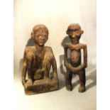 A Naga carved wood squatting figure, and a Cameroon standing figure, both mid 20th century, both