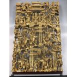 A Chinese gold painted carved wooden panel depicting pagodas and fighters, 62 x 40cm