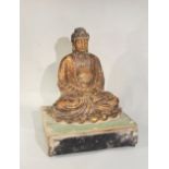 A Chinese gilded pottery seated Buddha in meditation on lotus dais, on wood stand, perhaps c1900