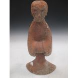 A Chinese red pottery standing lady attendant, probably Han Dynasty, 31.5cm high