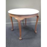 A Continental carved oak occasional table, with circular white marble top, on acanthus headed