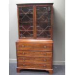 A George III mahogany secretaire bookcase with Greek key moulded cornice above two astragal glazed