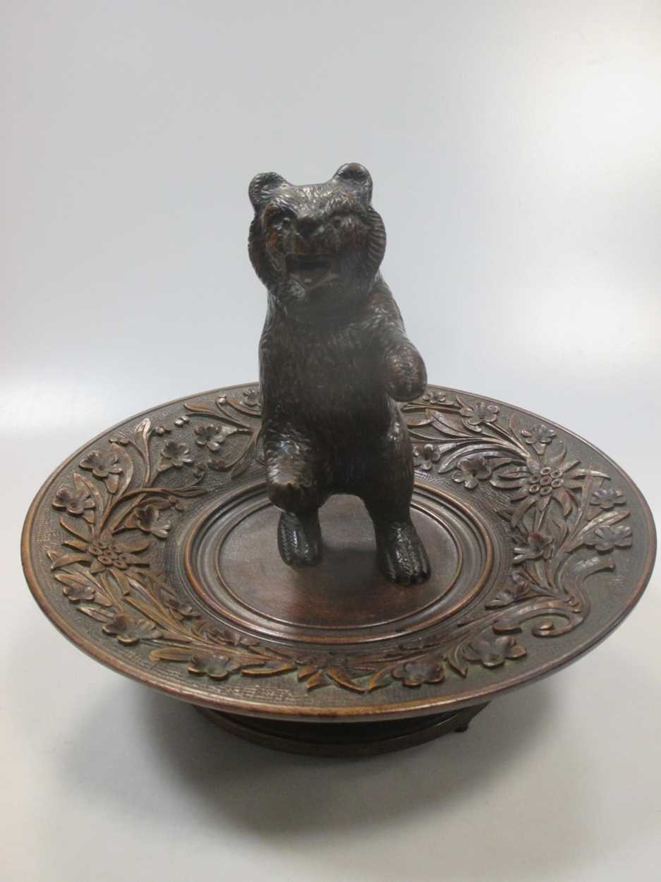 A carved walnut 'musical' bowl, probably Black Forest, and a carved model bear