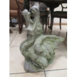 A lead garden statue of a seated dragon, 60cm high