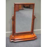 A Mid-Victorian flame mahogany dressing chest tilting mirror on turned supports and breakfront