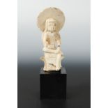 A Chinese white marble seated figure of Avalokiteshvara with aureole, in 6th/7th century Style, 24.