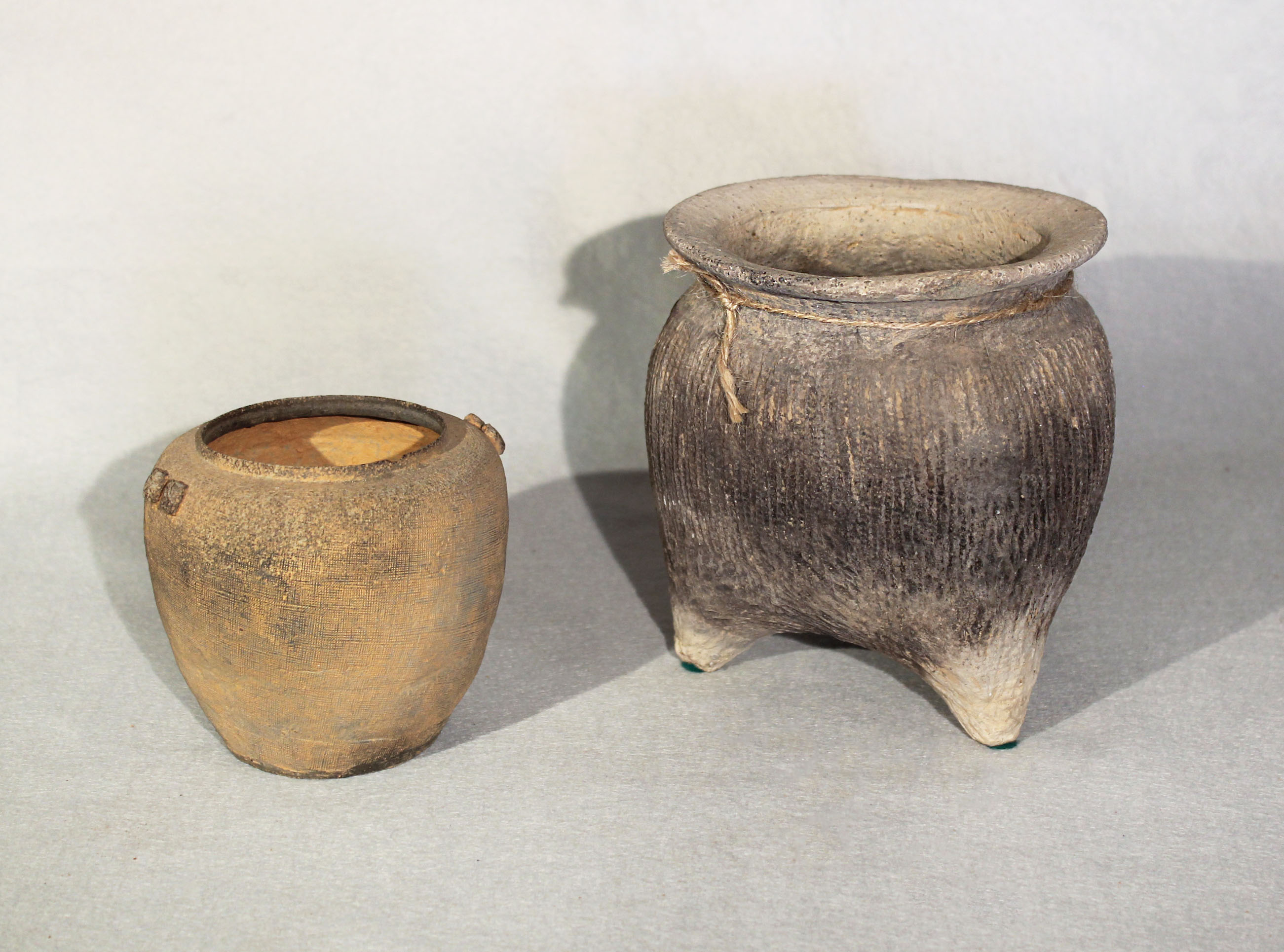 Two Chinese vases, comprising a three legged pot with impressed string lines, Neolithic, 16cm