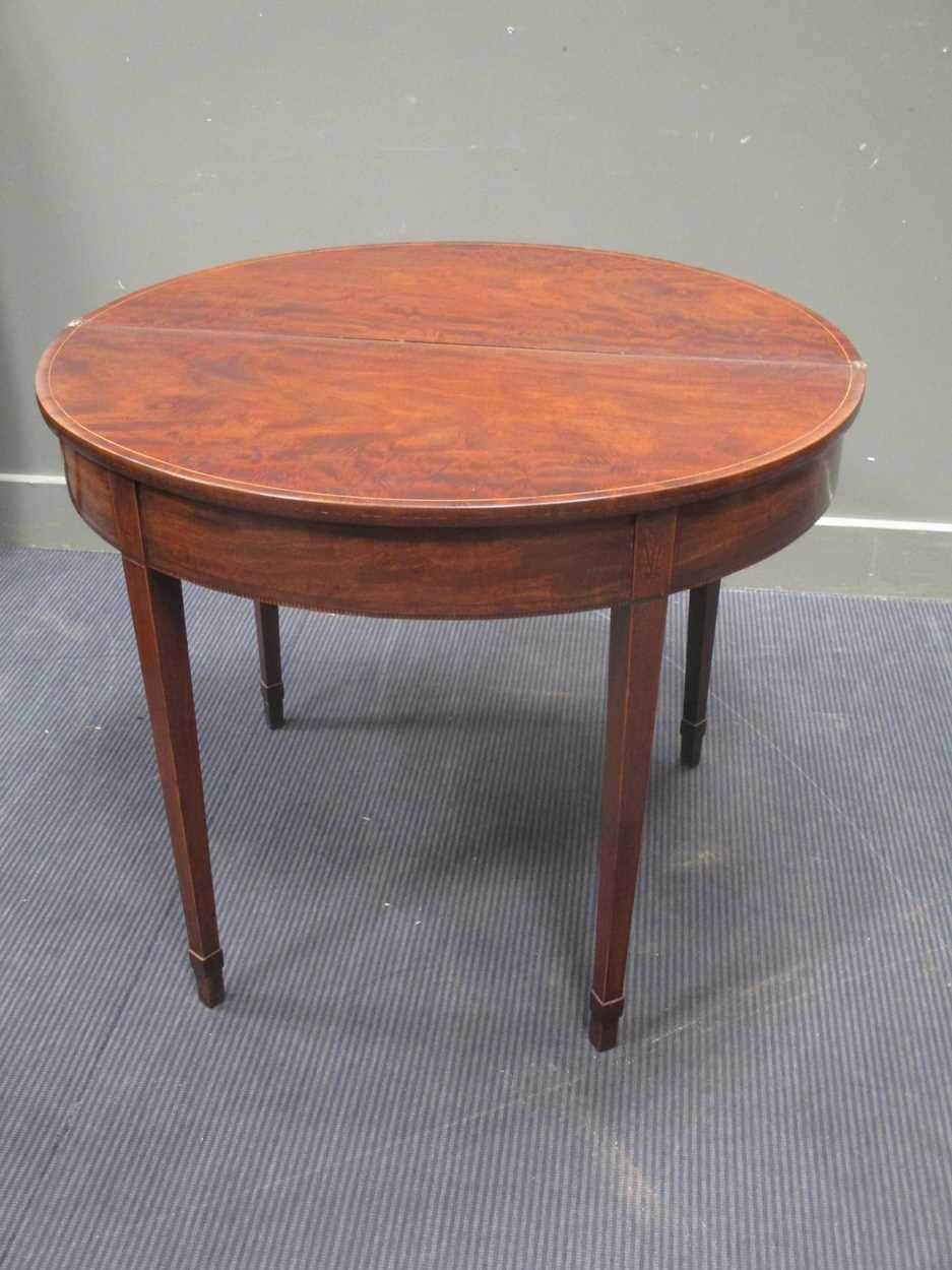 A George III mahogany demi-lune card table, with chevron banded top, on square tapering legs with - Bild 4 aus 5