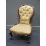 A Victorian walnut button back nursing chair with cabriole front legs