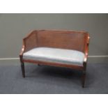 A pair of Continental cane-back beech wood settees, blue squab cushions, on square tapering