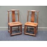 A pair of Chinese "yellow tree" hardwood chairs, circa 1900, with yoke shaped top rails, splats