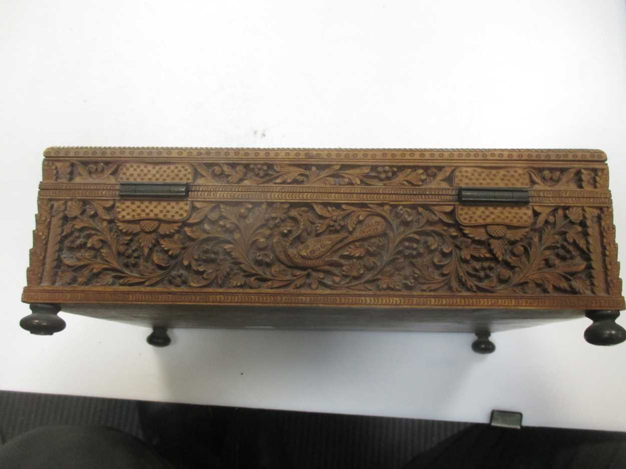 An Indian/Asian carved wood box, probably c.1900, with three figures to the lid, on brass feet, 23 x - Image 4 of 6