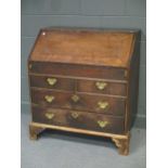 An 18th century oak and crossbanded bureau, the fall front revealving a fitted interior and well,