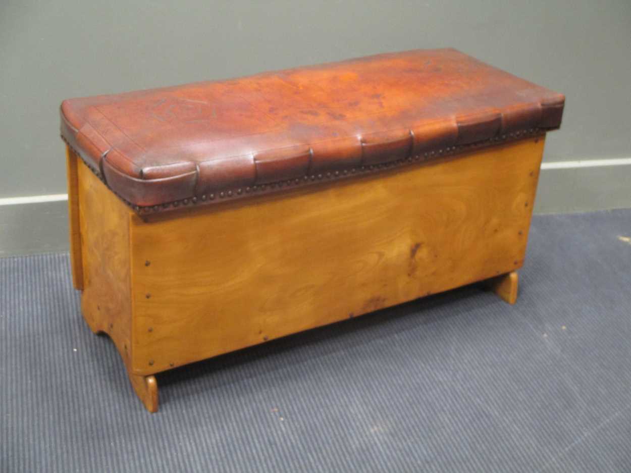 An embossed leather seat elm chest with Tudor rose decoration and woven seat borders 50 x 90 x 37cm