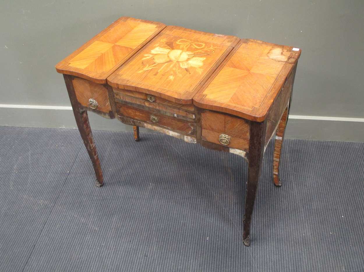 A French early 19th century kingwood and inlaid dressing table with three compartments, the