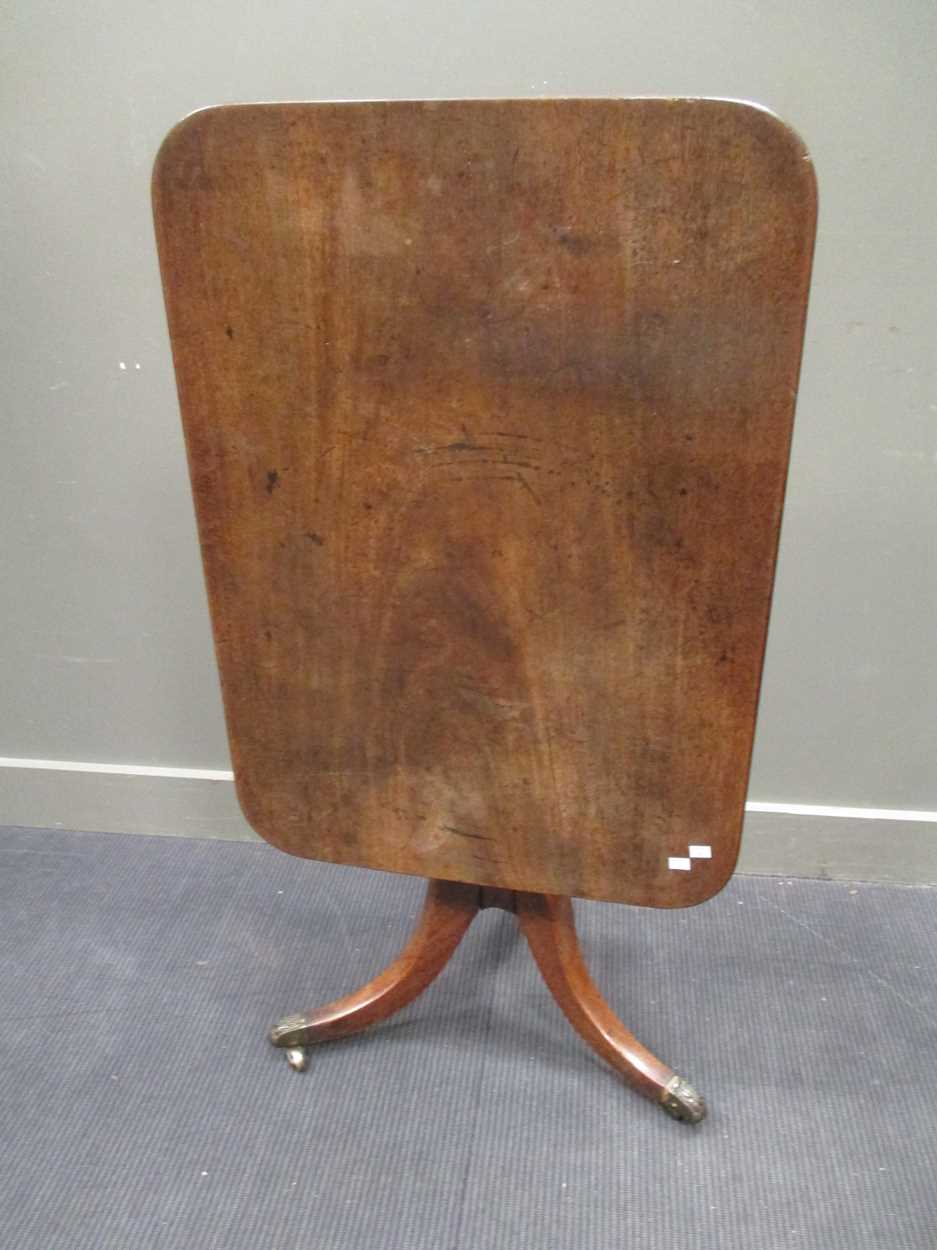 A George III mahogany breakfast table with brass lion paw feet, 72 x 91cm; a 19th century occasional