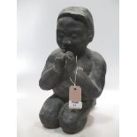 A Chinese black glazed porcellanous figure of a kneeling boy child, 20th century, 35cm high