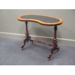 Circa 1840 walnut kidney shape writing table on turned and carved base with brass castors 72cm