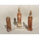 Three Chinese painted pottery standing figures, perhaps Han Dynasty, of a lady and two men,