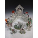 Nine Victorian Staffordshire pottery figures, a continental porcelain figure, and two copper