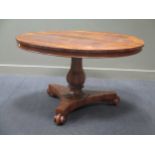 A late Georgian rosewood breakfast table, the circular top upon a faceted baluster column support