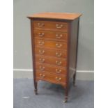 A mahogany music cabinet with seven drawers, on castors, 101 x 50.5cm; and an Edwardian inlaid