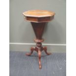 A Victorian walnut octagonal top trumpet work table on tripod base