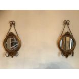 A pair of gilt composition mirrored wall sconces, 80cm high