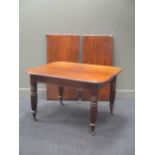 A Victorian mahogany dining table with two leaves