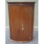 A George III mahogany bow front corner cupboard, 109 x 70cm