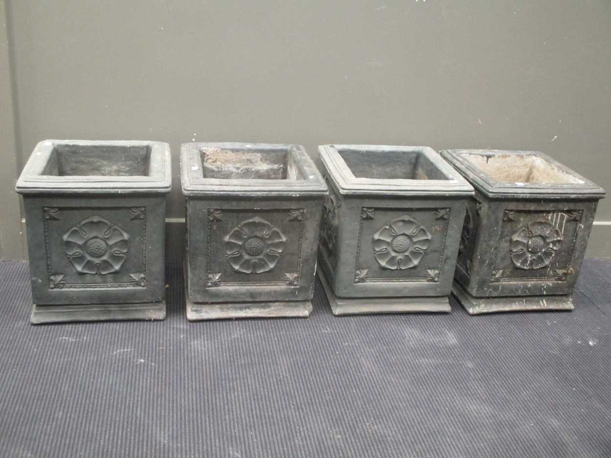A set of four painted concrete planters with rosette decoration, 40cm square.
