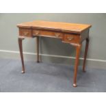 An early 19th century walnut breakfront card/ side table, the swivel top over three frieze drawers