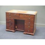 A 19th century mahogany kneehole desk of nine drawers, the bracket feet possibly reduced in size