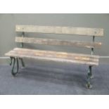 A green painted cast iron 'serpent' pattern garden bench with wooden back and seat, 151cm wide