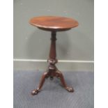 Circa 1850 a mahogany circular top wine table on turned and carved column with tripod base 77cm high
