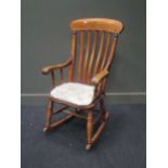 A beech and elm lath back rocking chair