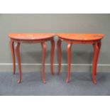 A pair of red japanned bow fronted bedside or hall tables (2)