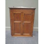 An early 19th century oak hanging corner cupboard 100 x 80cm