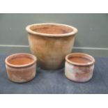 A large plain terracota circular planter, 69cm and a pair of smaller circular planters 38.5 (3)