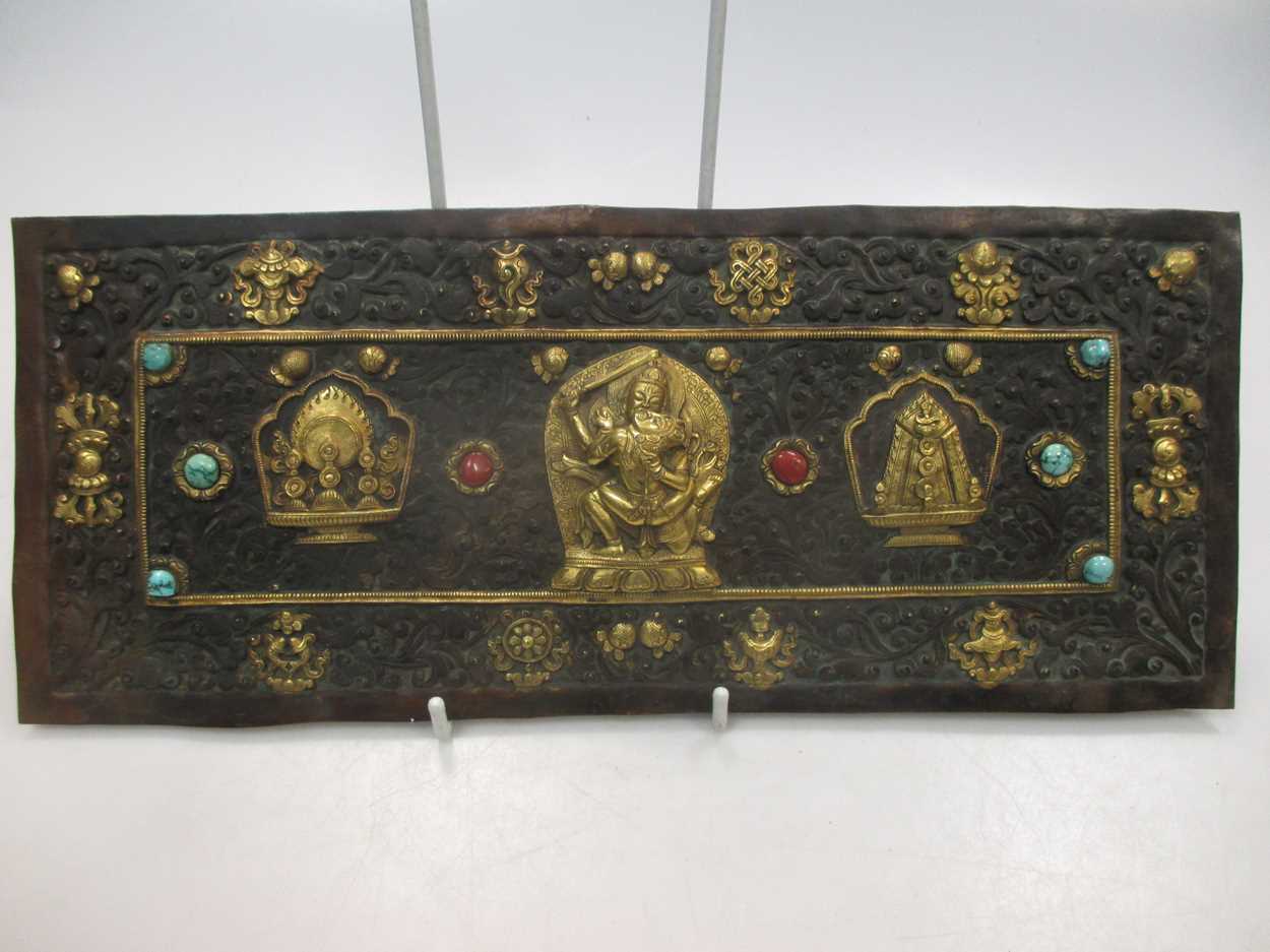 A possibly Tibetan rectangular metal embossed plaque gilt mounts