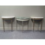 A pair of ebonised and gilt console tables on fluted tapering legs 73cm wide and a green and white