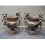 A pair of large modern reproduction bronze urn with lion mask loop handles and pair of cherubs